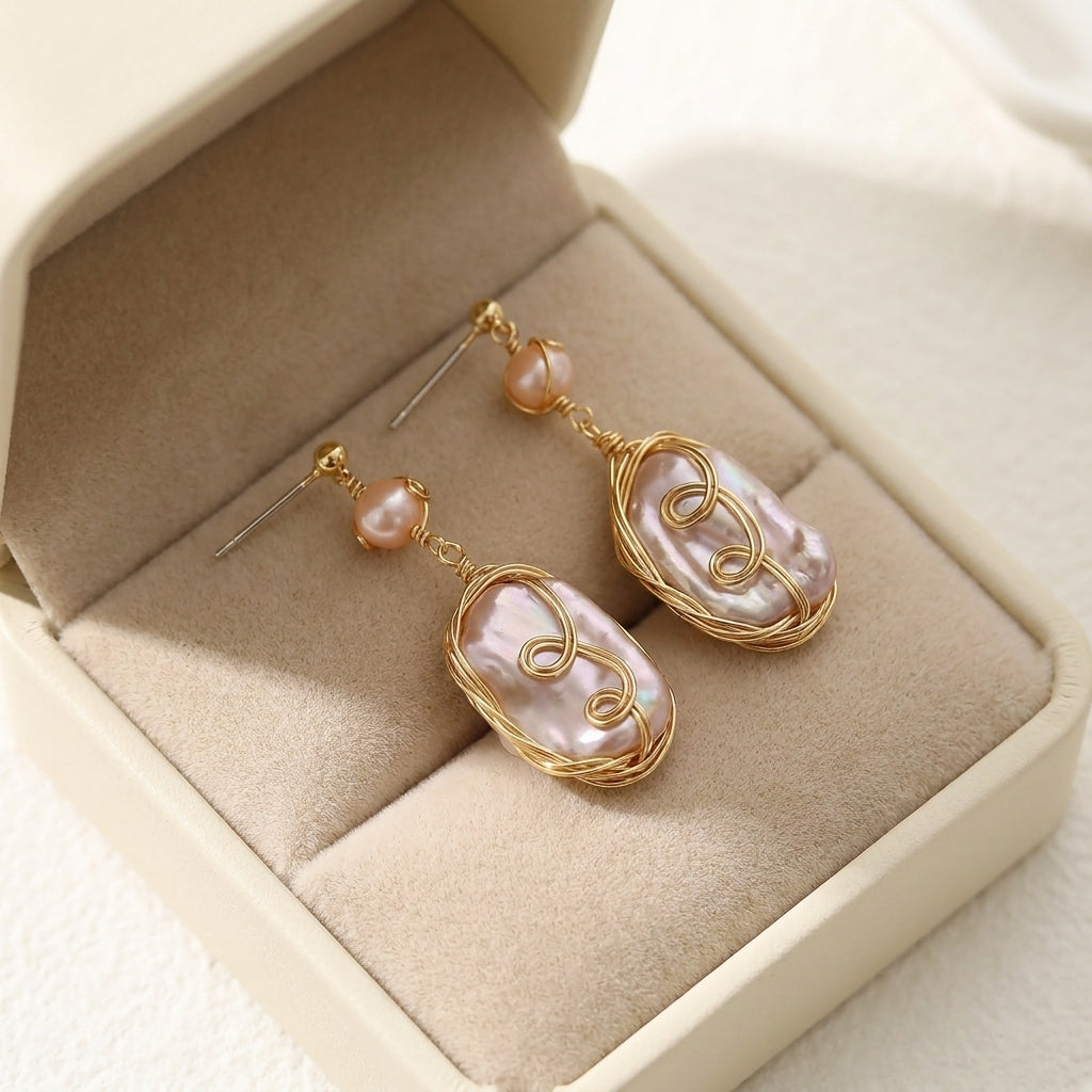 The Twilight Reverie iridescent baroque pearl earrings presented in a premium beige jewelry box, ideal for a luxury anniversary or wedding gift by Whisperland Studio.