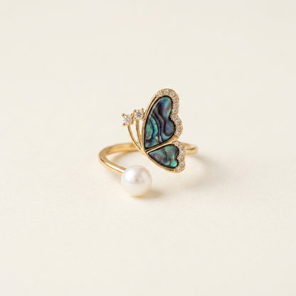 Aura Abalone Butterfly Ring with natural freshwater pearl on model's finger by Whisperland Studio