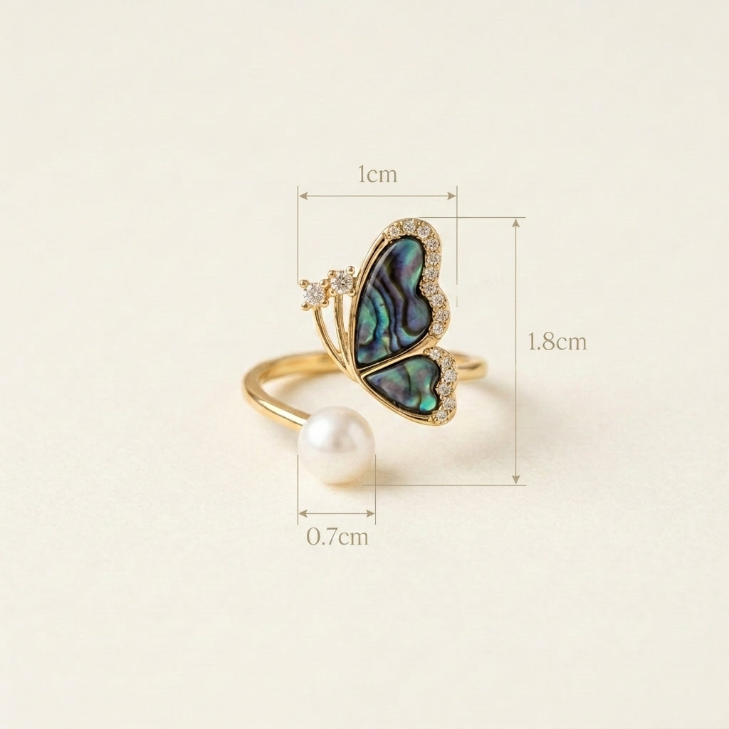 Model wearing the Aura butterfly ring in natural light to show color-shifting shell wings
