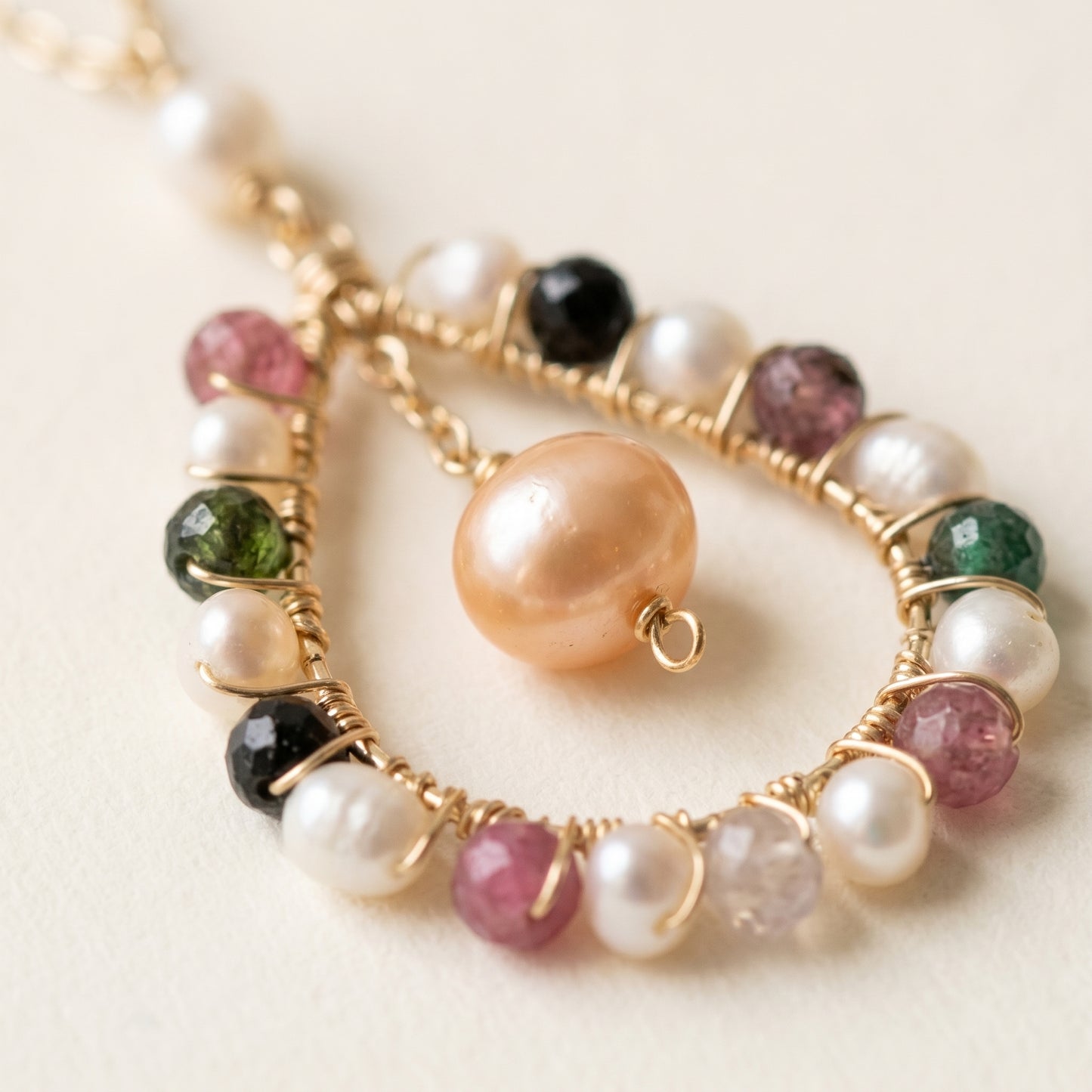 Bracelet with pearls and gemstones on a light background