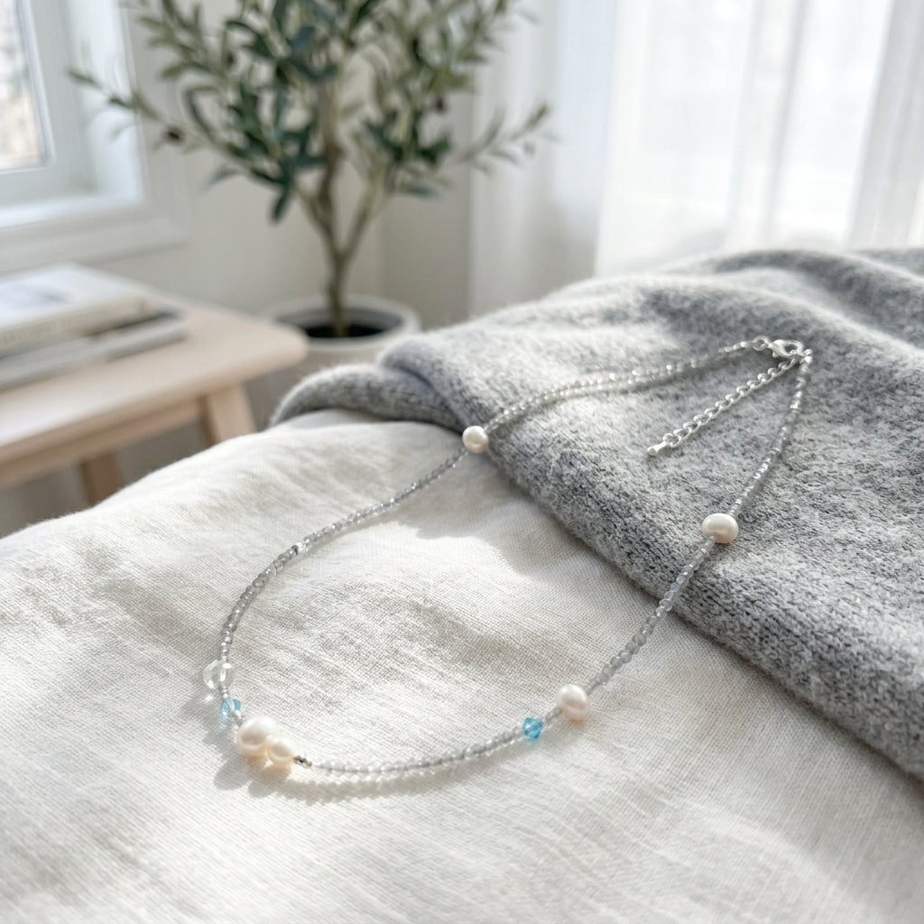 Minimalist handmade gemstone jewelry with natural moonstone and aquamarine crystal beads in soft lighting