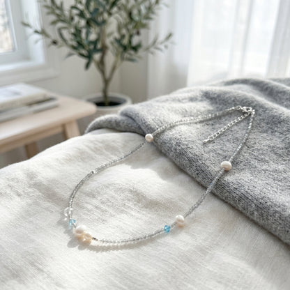 Minimalist handmade gemstone jewelry with natural moonstone and aquamarine crystal beads in soft lighting