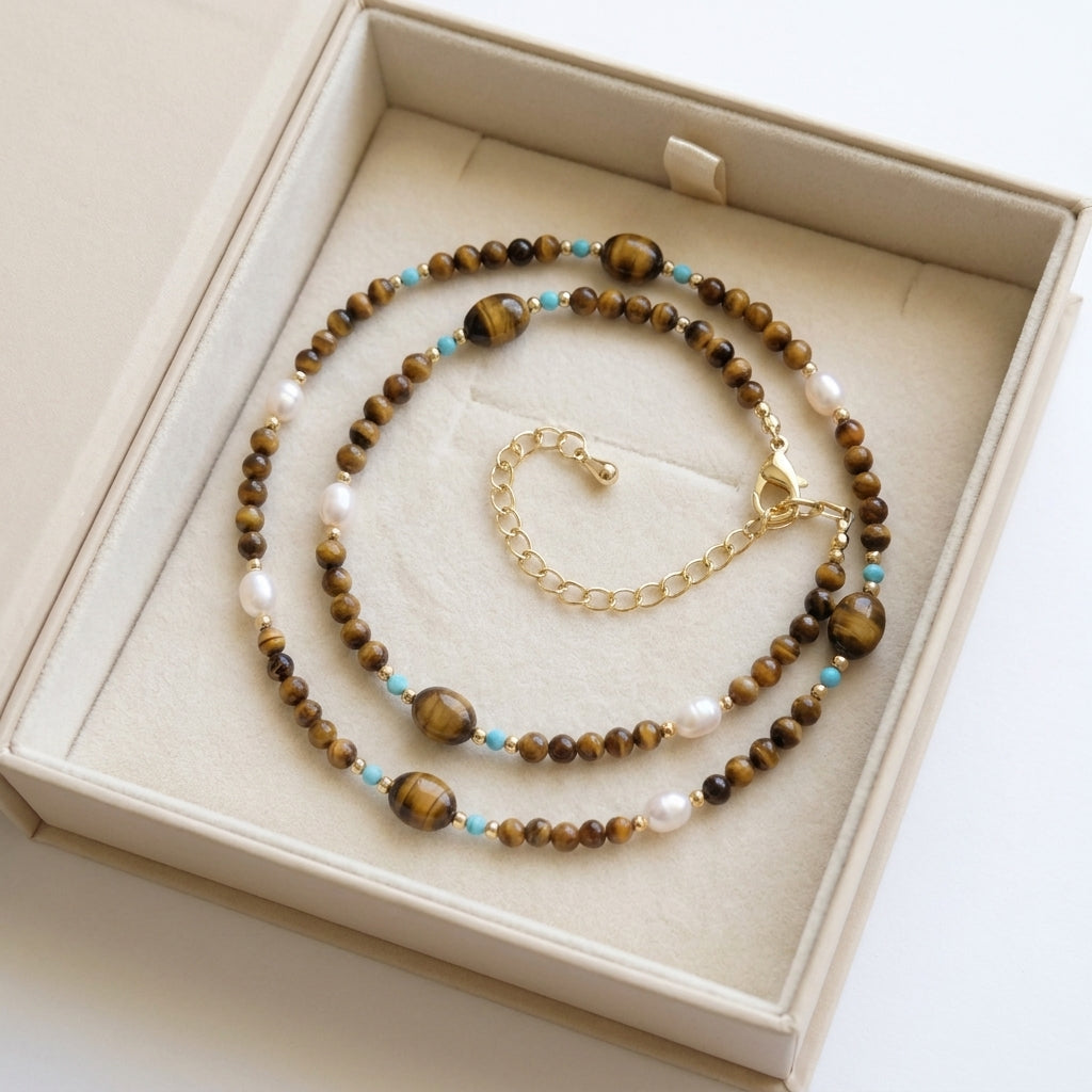 Necklace with tiger eye stones and pearls in a beige box