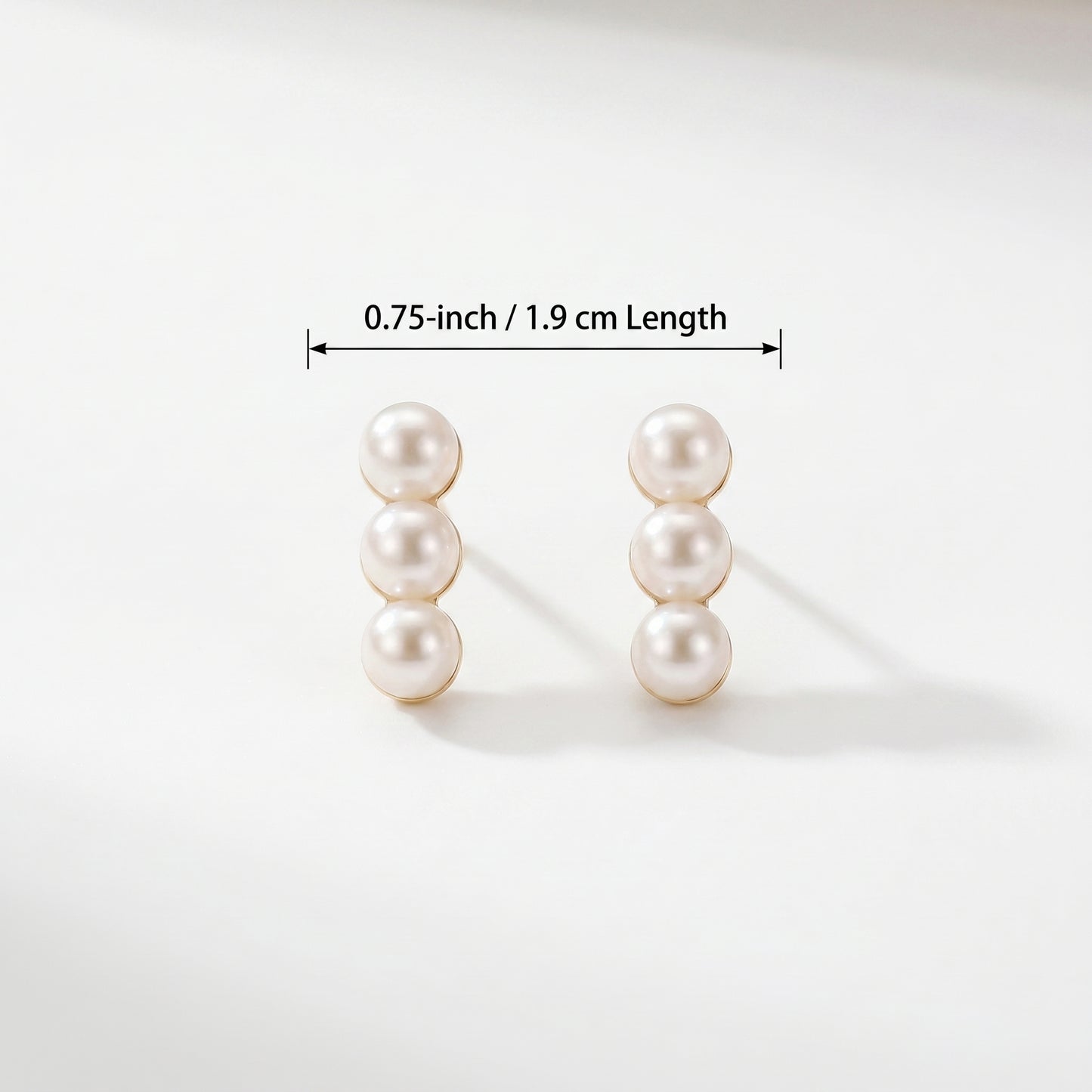Size guide and dimension diagram for the Lumina Trio three-pearl linear stud earrings.