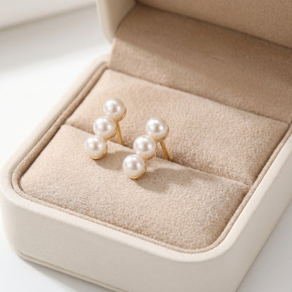 Lumina Trio freshwater pearl earrings beautifully displayed in a beige velvet jewelry gift box.