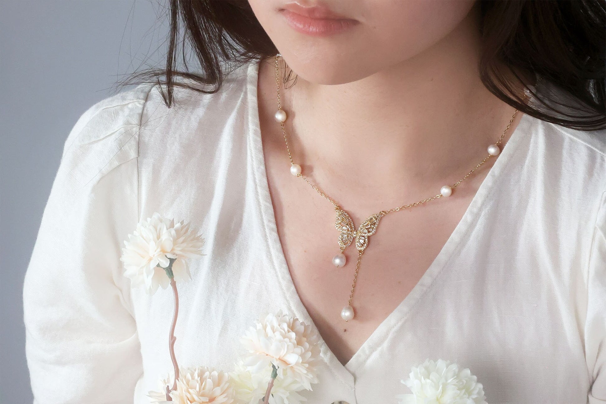 Front view of the delicate gold butterfly necklace with natural pearl drop, dainty wedding jewelry