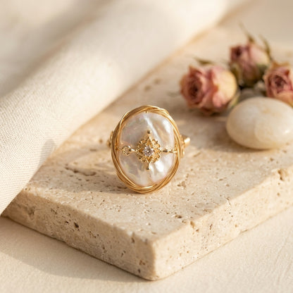 Hand wearing The 'Aurelia' wire wrapped statement pearl ring, displaying the elegant drape of the vintage zircon charm
