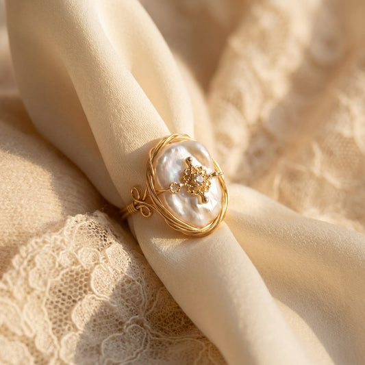 pearl-ring-stone	The 'Aurelia' 14K gold plated wire wrapped baroque pearl ring with vintage charm displayed on a textured stone by Whisperland Studio.