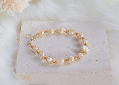 Dainty Seraphina pearl bracelet resting on a decorative surface - Elegant jewelry display