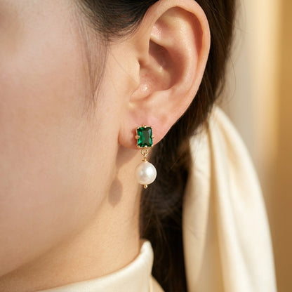 Model wearing the “Eden’s Whisper” Emerald and Freshwater Pearl Drop Earrings in 14K Gold