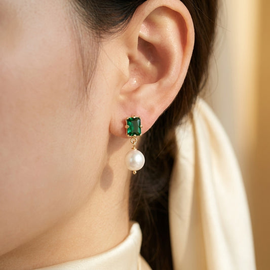 Model wearing the “Eden’s Whisper” Emerald and Freshwater Pearl Drop Earrings in 14K Gold
