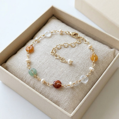 The Elara dainty gemstone bracelet beautifully packaged inside an elegant beige Whisperland Studio jewelry gift box.