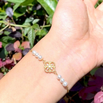 Elegant everyday styling of the Aurelia 18K gold plated vintage pearl charm bracelet by Whisperland Studio.