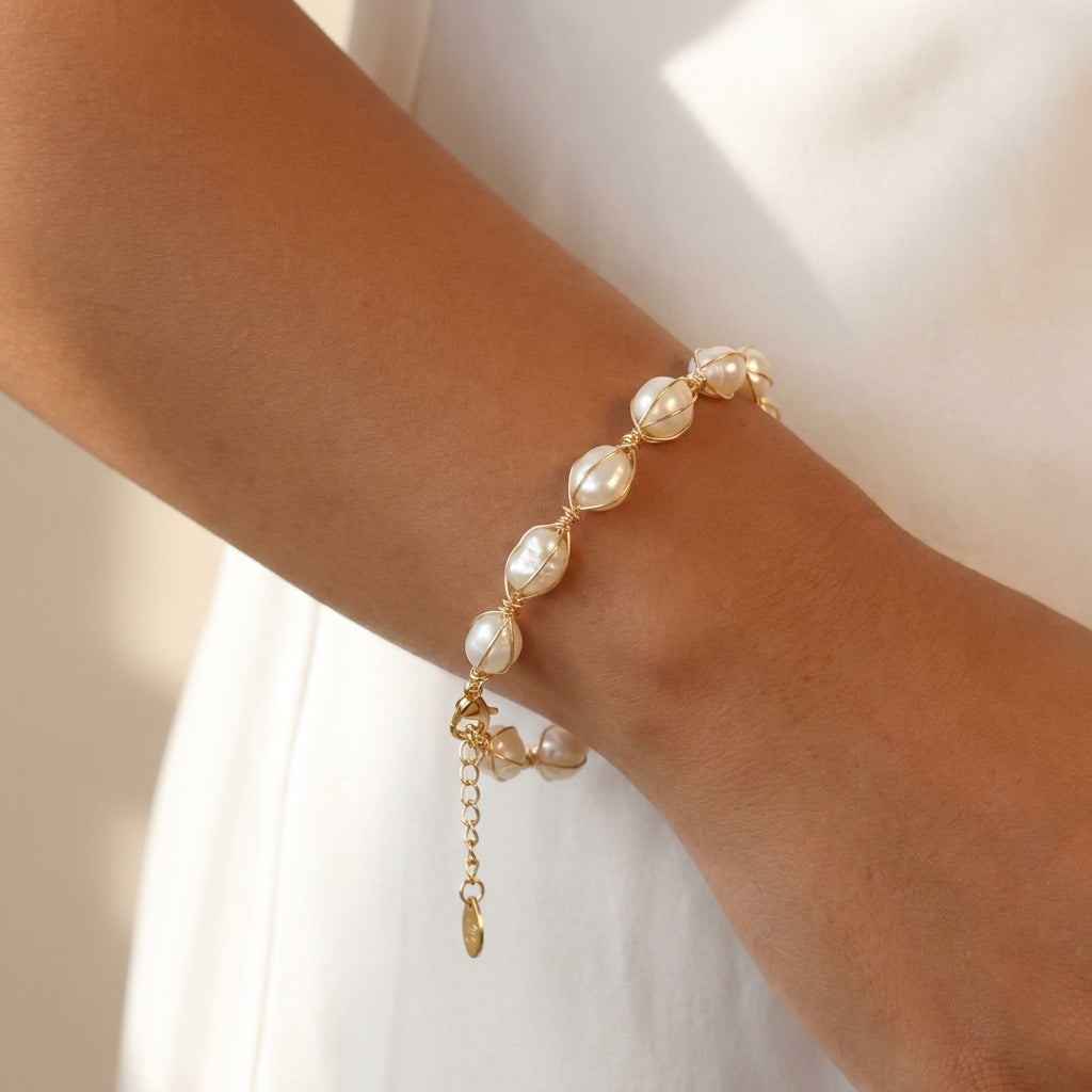 Angled perspective of the handcrafted gold wire wrapping on the pearl bracelet