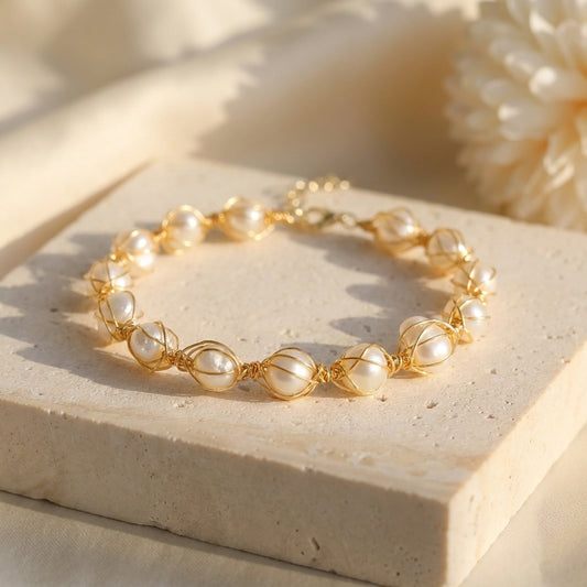 Top-down view of The Handmade Freshwater Pearl Wire Wrapped Gold Bracelet by Whisperland Studio