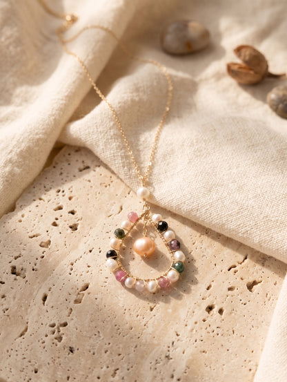 Necklace with multicolored beads on a textured beige surface