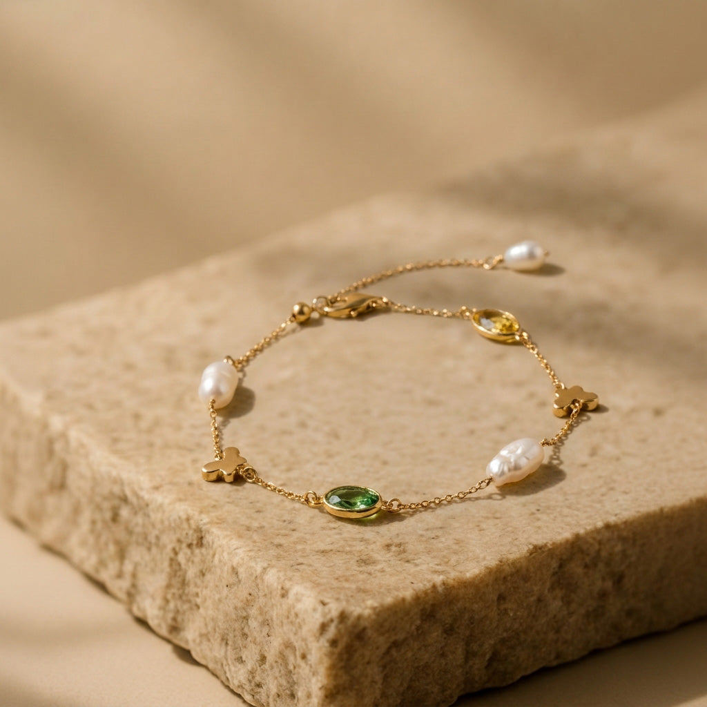 Detailed view of the whimsical 18K gold-plated butterfly charm on the Papillon minimalist bracelet.