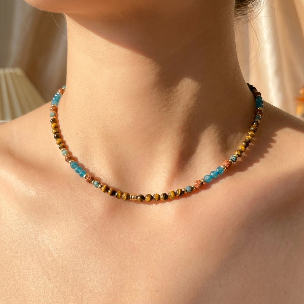Woman wearing the minimalist Terra Aura beaded gemstone choker necklace by Whisperland Studio.