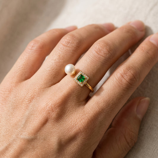 The 'Muse' Emerald & Freshwater Pearl Open Ring worn on a woman's hand, minimalist gold jewelry by Whisperland Studio.