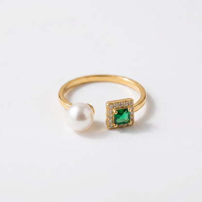 Close up of The 'Muse' 14K gold adjustable ring featuring an emerald-cut stone and three freshwater pearls on a white background.