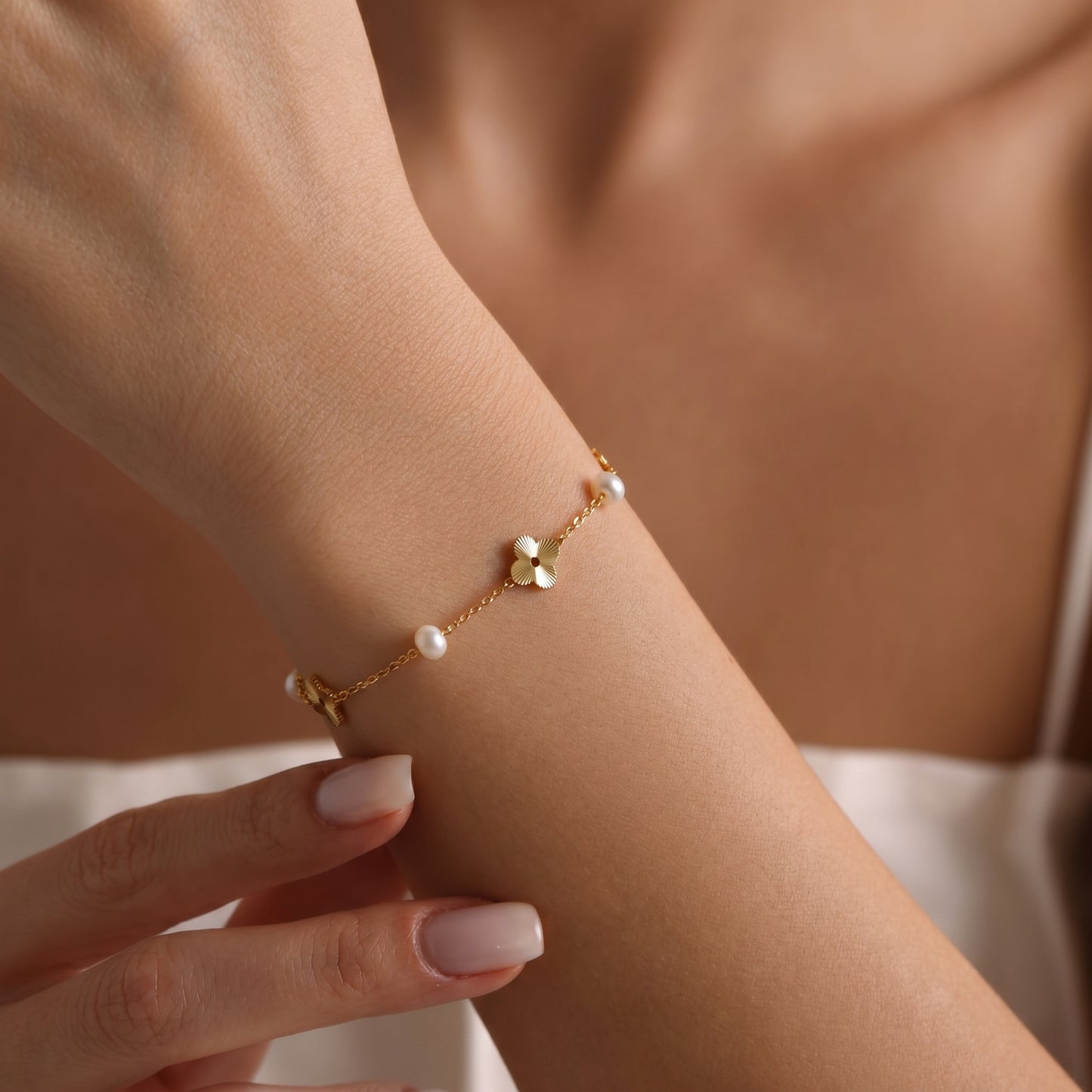 Close-up of the adjustable 14K gold extension chain and secure clasp on the dainty freshwater pearl bracelet.