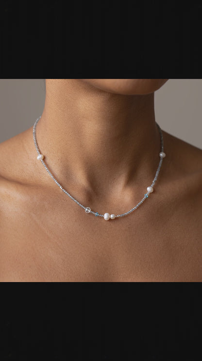 Model wearing the Aetheris Lunar Dew dainty silver choker featuring freshwater pearls and aquamarine by Whisperland Studio