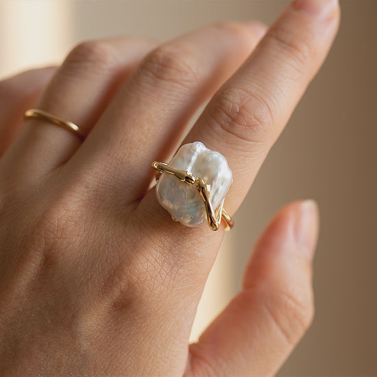 pearl-ring-video	Video showcase of The 'Embrace' sculptural baroque pearl ring worn on a hand, displaying its unique 14K gold plated open band design.