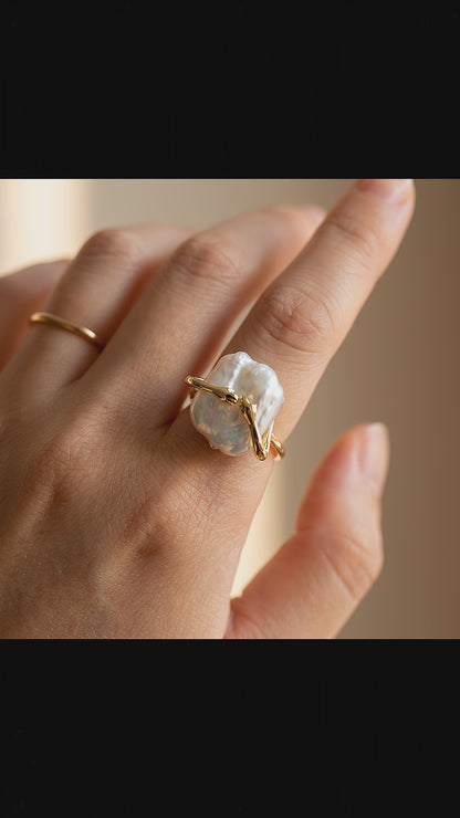 pearl-ring-video	Video showcase of The 'Embrace' sculptural baroque pearl ring worn on a hand, displaying its unique 14K gold plated open band design.
