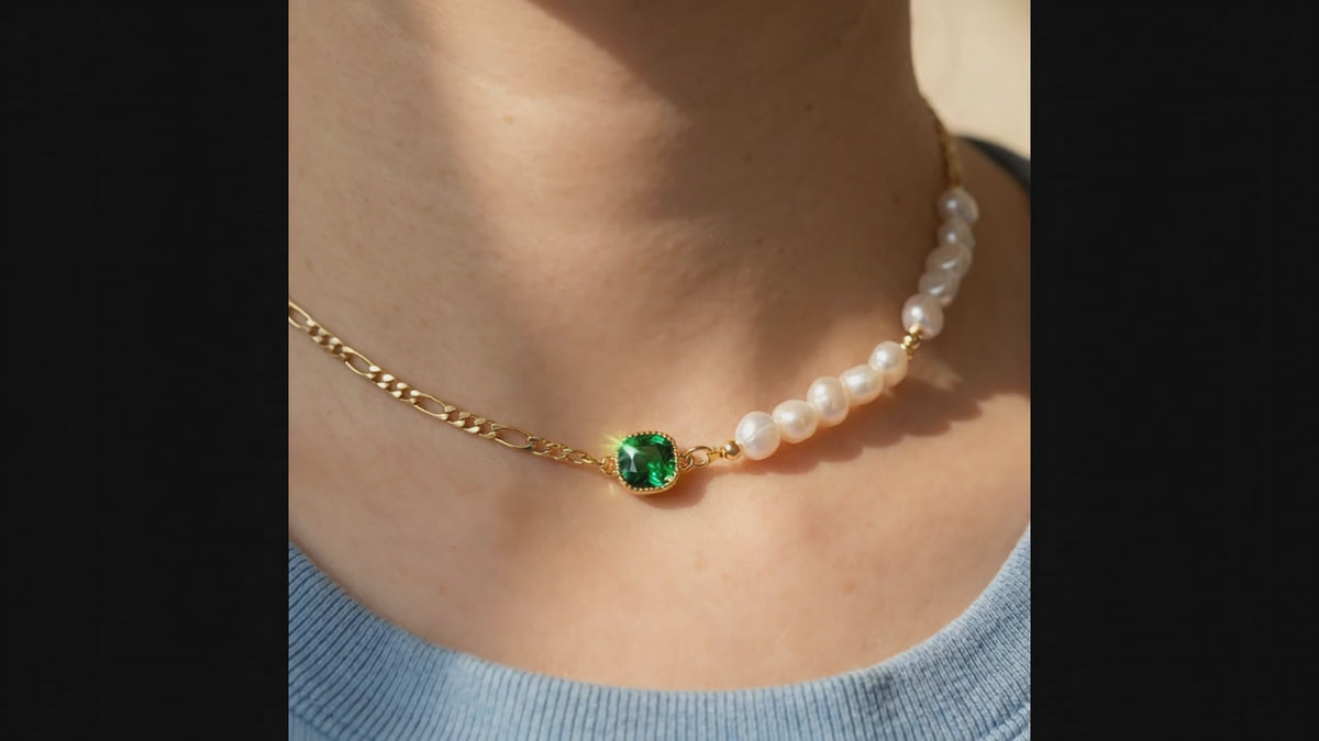 ASMR video showcase of the “Verdant Muse” Emerald and Pearl Choker featuring the 14K gold figaro chain and natural gemstone shimmer