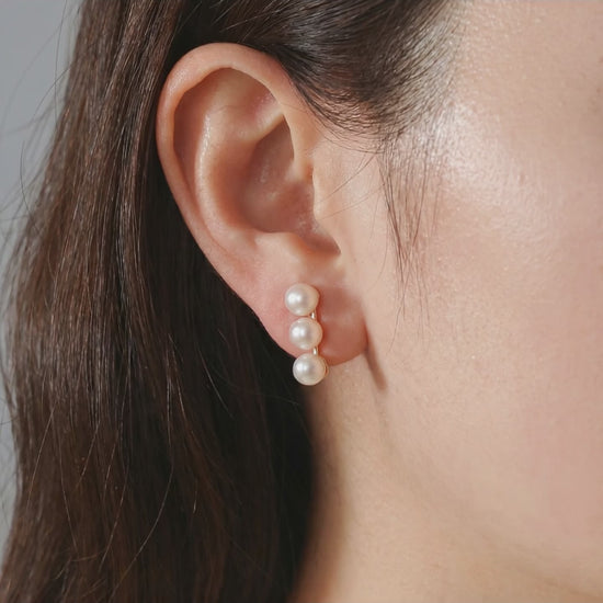 Video showcasing the subtle iridescence and elegant fit of the Lumina Trio pearl stud earrings.