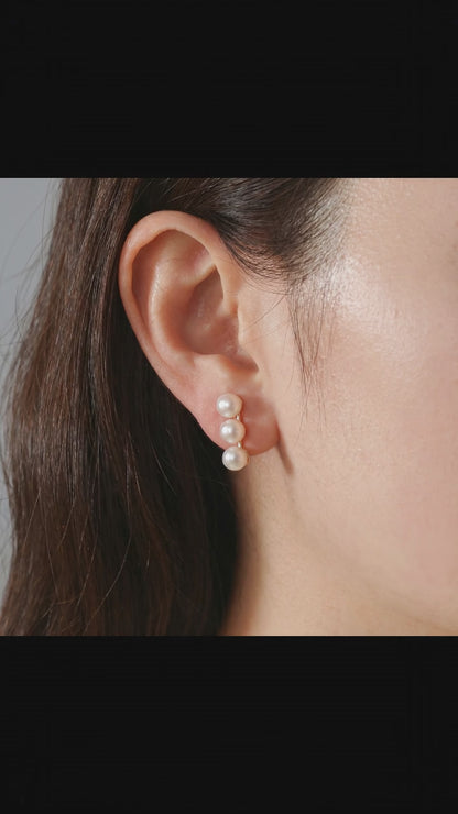 Video showcasing the subtle iridescence and elegant fit of the Lumina Trio pearl stud earrings.