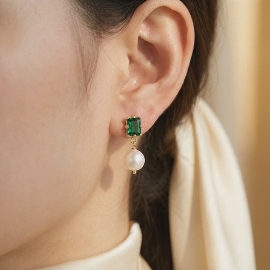 Video showcase of the “Eden’s Whisper” Emerald and Freshwater Pearl Drop Earrings featuring the elegant sparkle of the emerald and luster of the pearl