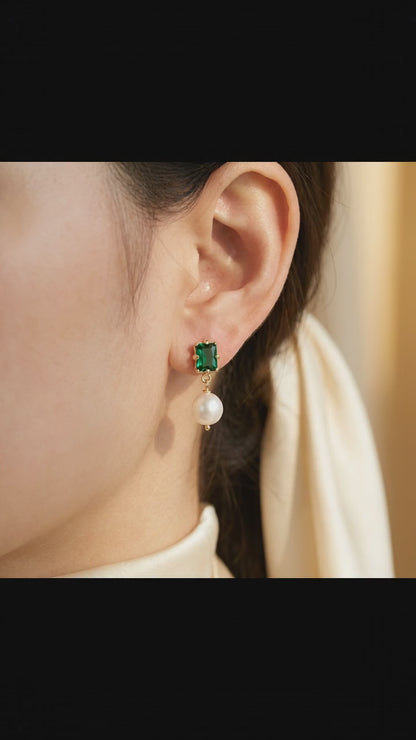 Video showcase of the “Eden’s Whisper” Emerald and Freshwater Pearl Drop Earrings featuring the elegant sparkle of the emerald and luster of the pearl
