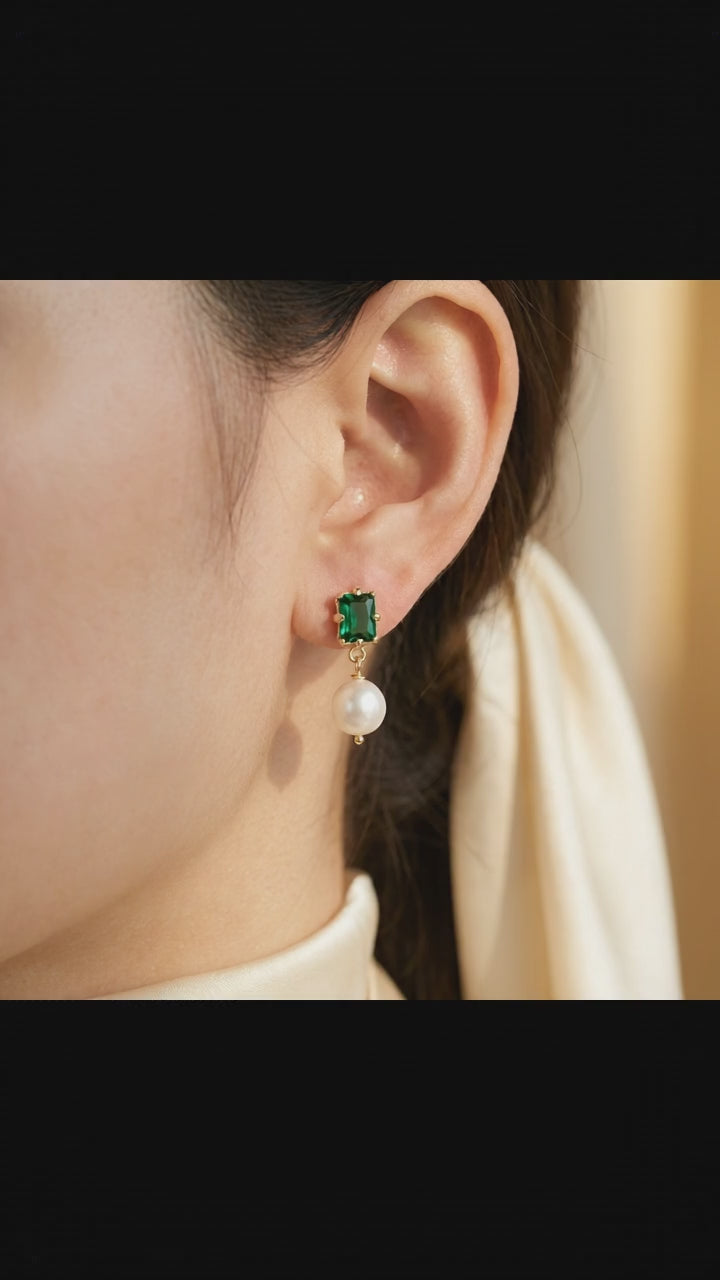 Video showcase of the “Eden’s Whisper” Emerald and Freshwater Pearl Drop Earrings featuring the elegant sparkle of the emerald and luster of the pearl