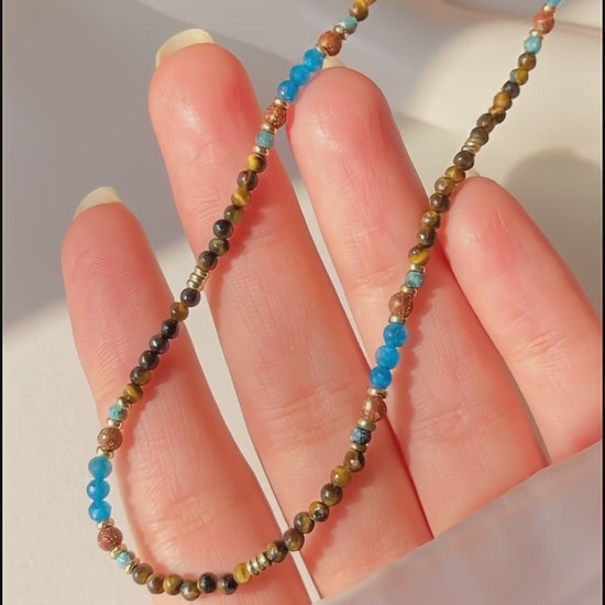 Video showcasing the light handmade details and natural shimmer of the Terra Aura gemstone necklace.