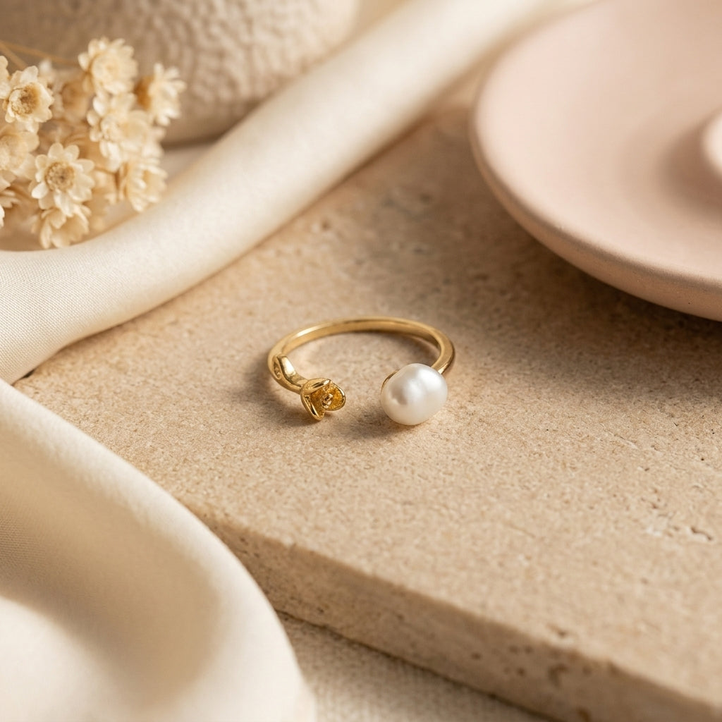 Macro detail of the handcrafted gold rose and natural freshwater baroque pearl on The 'Rosalie' adjustable ring.