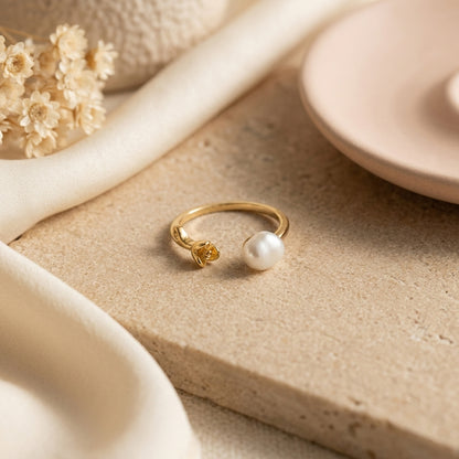 Macro detail of the handcrafted gold rose and natural freshwater baroque pearl on The 'Rosalie' adjustable ring.